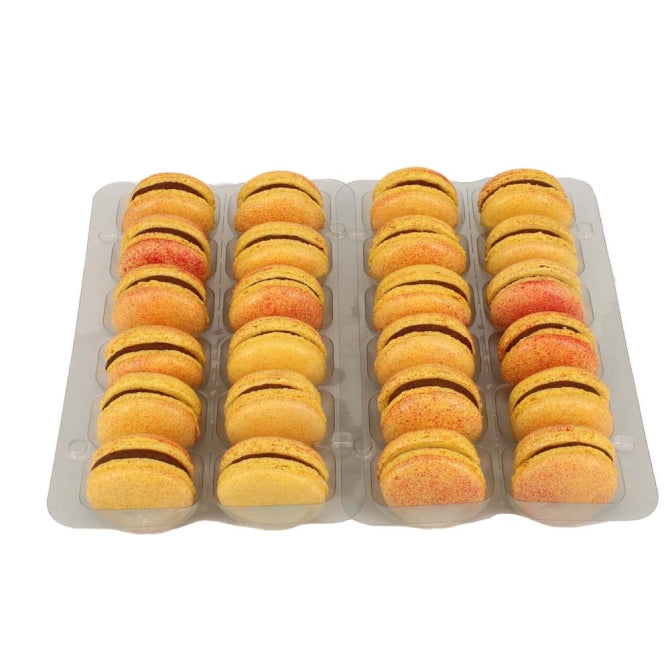 A tray of yellow and pink Passionfruit & Milk Chocolate macarons with visible chocolate ganache filling.