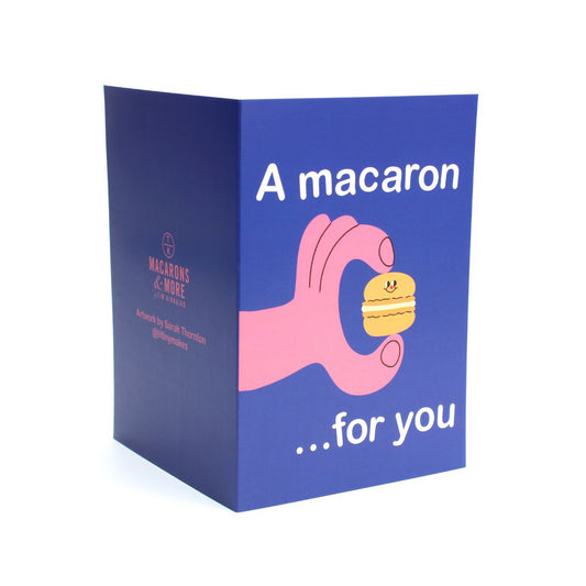 Card with a hand holding a macaron and text 'A macaron ...for you' 