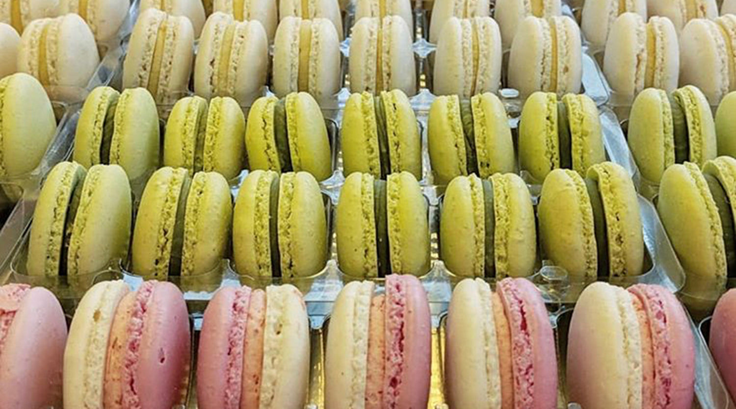 A side on image of lots of macarons, arrange for display in our shop.