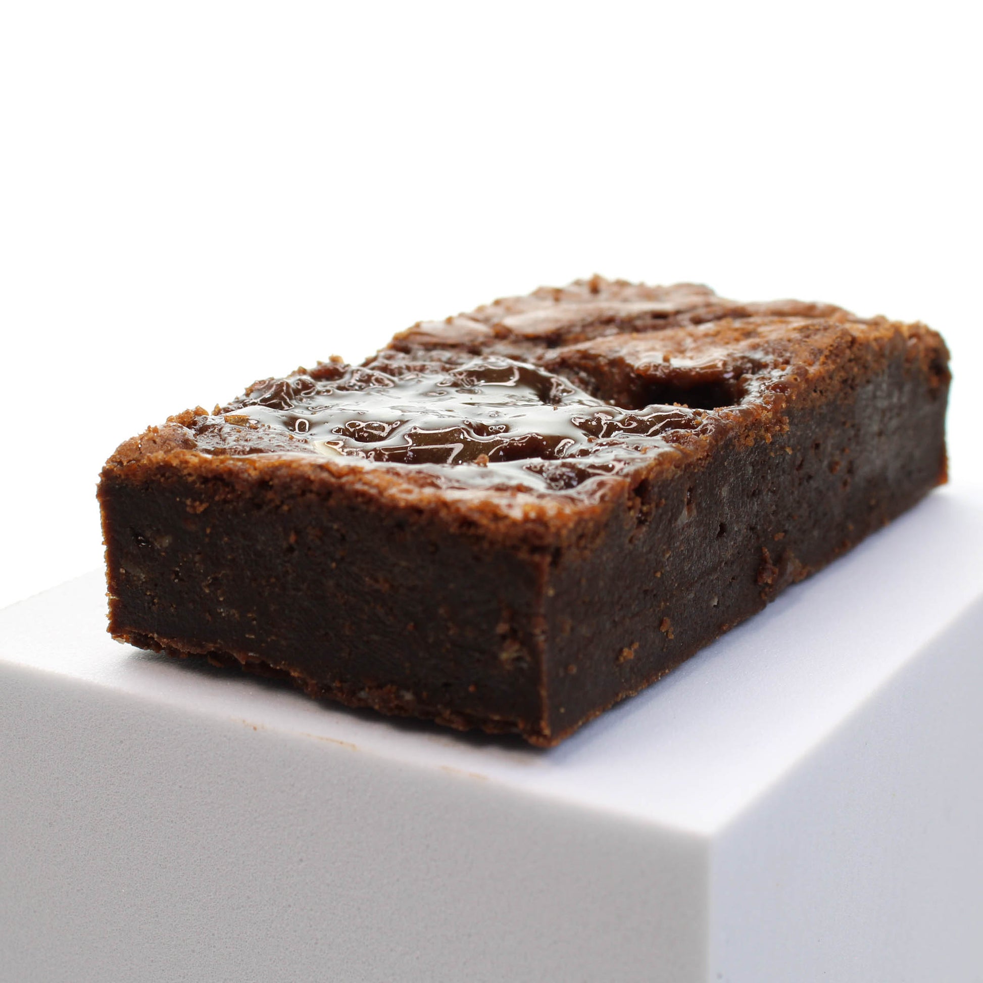 Brownie showing the oozy caramel. Choose this homemade brownie for your brownie gift box.