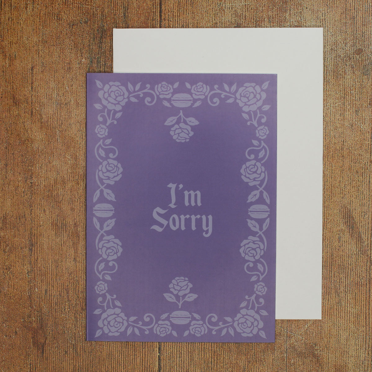 Purple card with floral border and 'I'm Sorry' text on a wooden surface