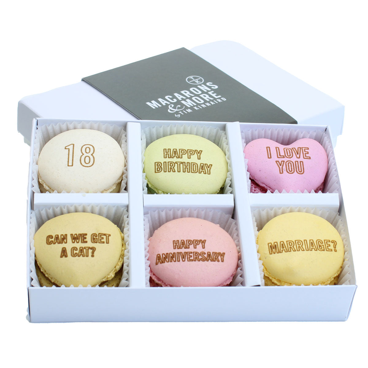 Box of personalised branded macarons in a white box with Macarons & More branding.