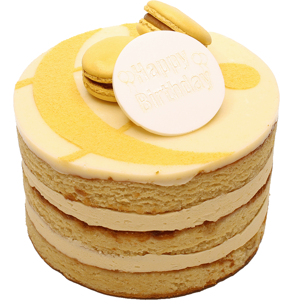 A Salted Caramel cake with multiple layers, toped with icing, macarons and a curly ampersand design and a 'Happy Birthday' plaque.