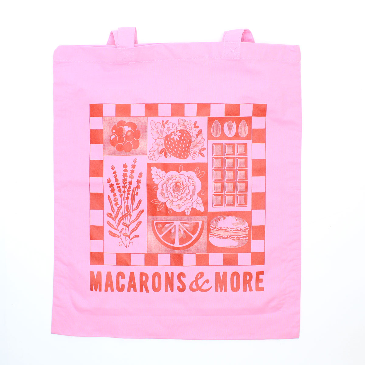 Pink tote bag with food illustrations and 'Macarons & More' text on a white background