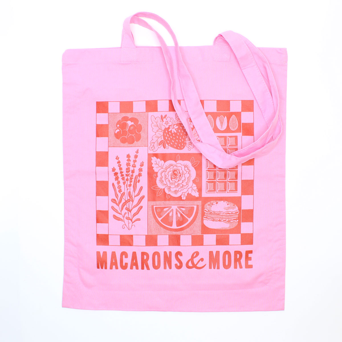 Pink tote bag with a checkered pattern and 'Macarons & More' text on a white background