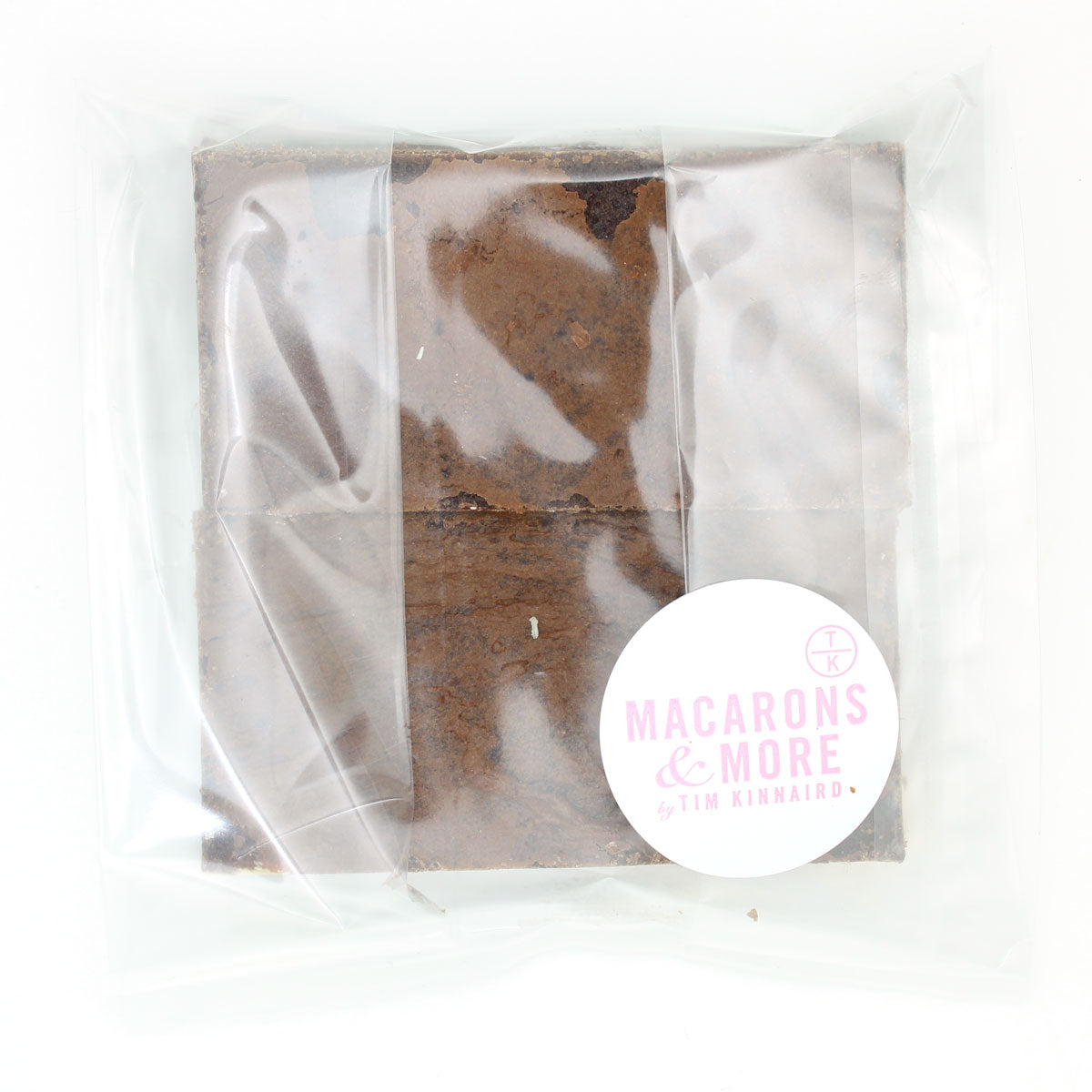 Two packaged white chocolate chip brownies with a Macarons and More label 