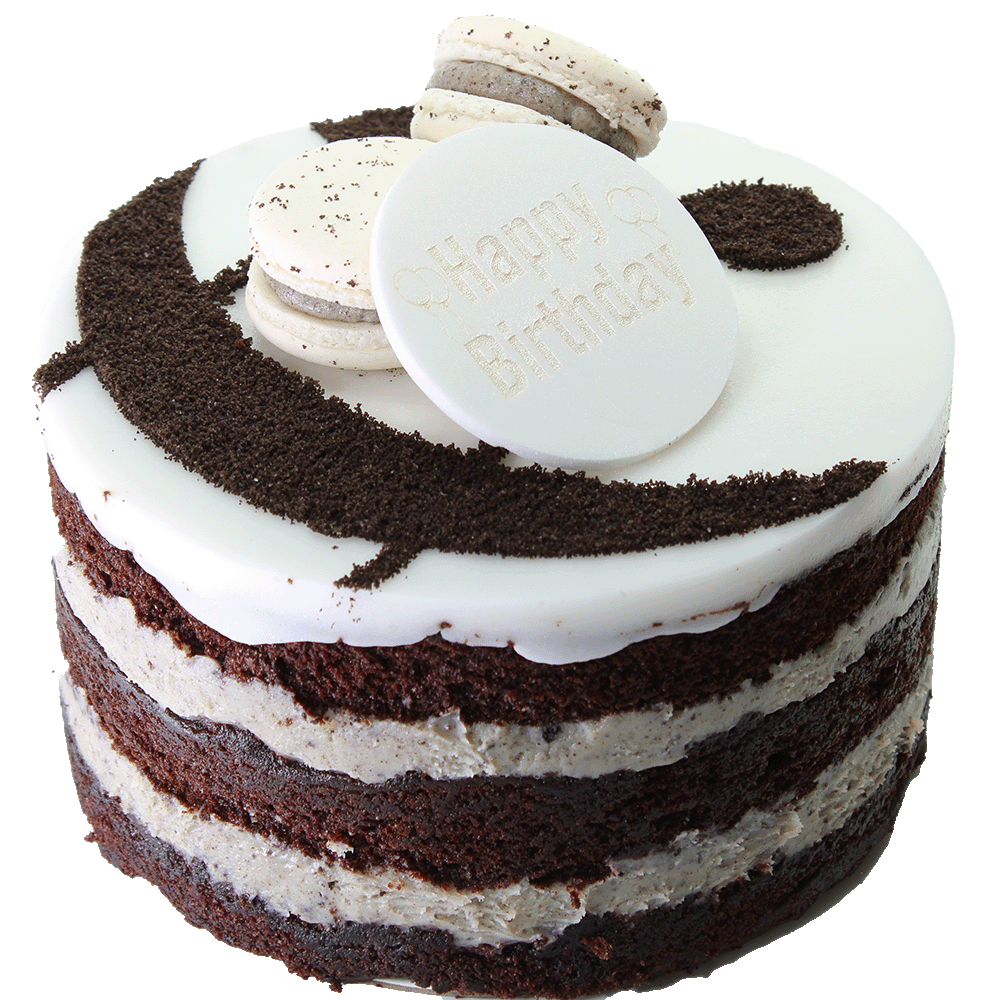 A Cookies & Cream cake with multiple layers, toped with icing, macarons, and ampersand design and a 'Happy Birthday' plaque.