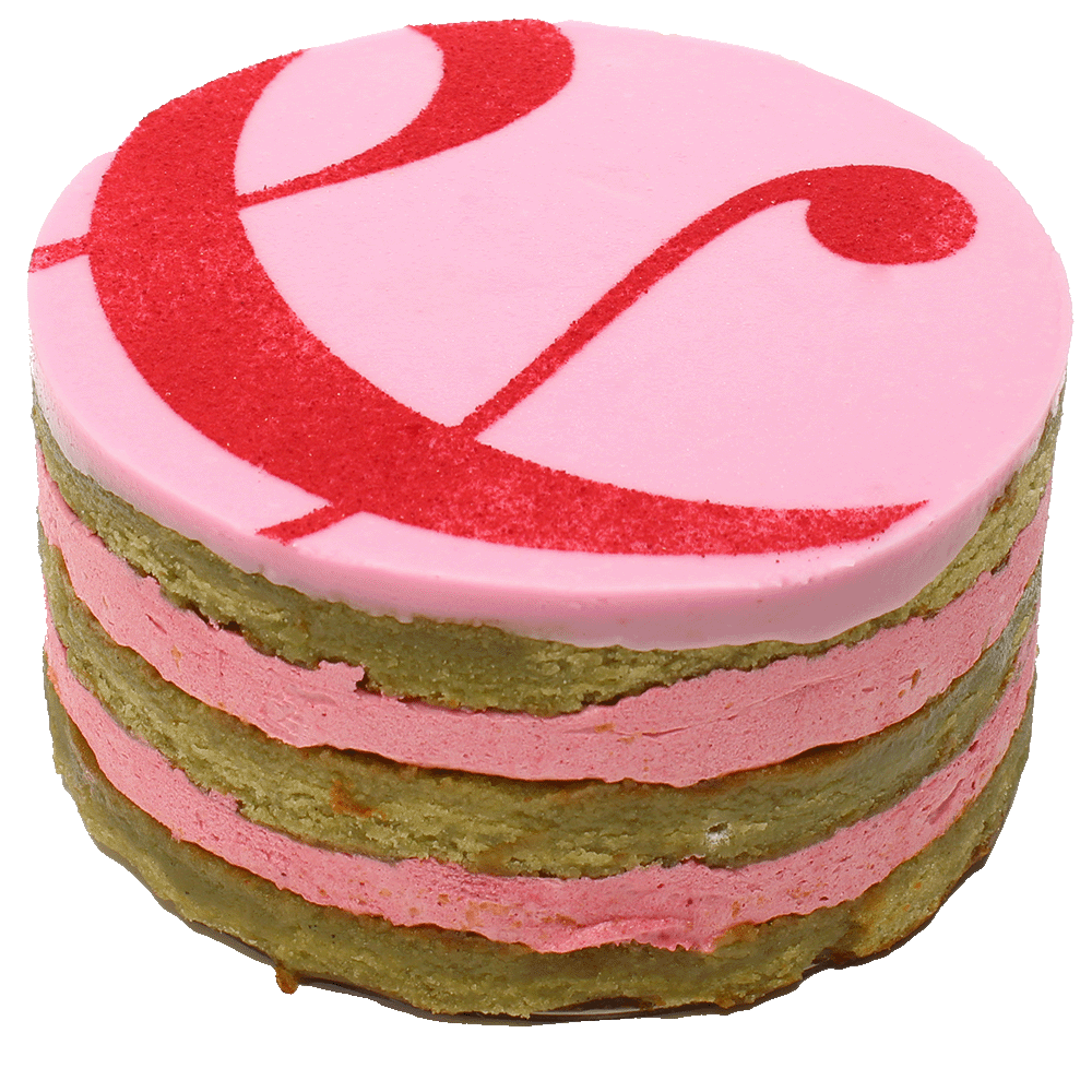 A Raspberry & Pistachio cake with multiple layers, toped with icing and a curly ampersand design.